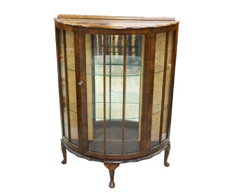 WALNUT BOW FRONT DISPLAY CABINETwith a raised back above a wavy rim bow front with beaded glass panels flanking a similar doo