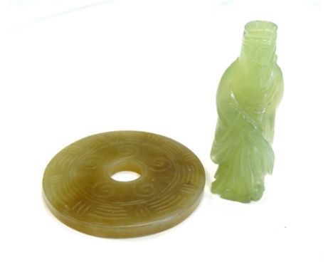 CARVED JADE DISC PENDANTwith linear and scroll decoration, together with a small carved jade figure (2)