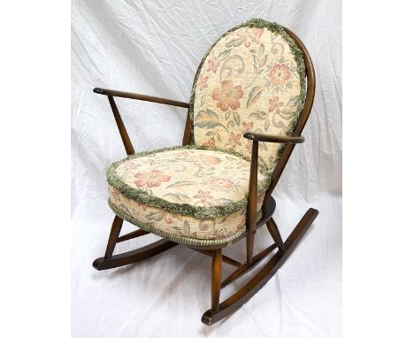 'ERCOL' ROCKING CHAIRwith floral fabric covered backrest and seat, labelled to underside and dated 1980