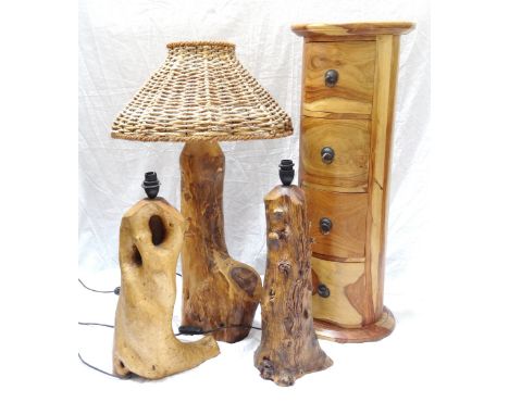 HARDWOOD SLIM CYLINDRICAL CHESTof four drawers, 77cm high, and three natural wood lamp bases, one of a phallic nature and 50.