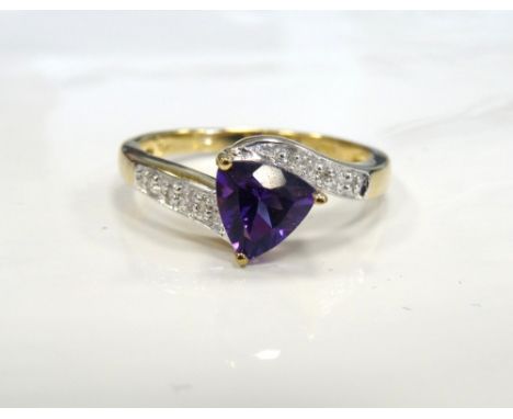 AMETHYST AND DIAMOND RINGthe central trillion cut amethyst flanked by diamond set shoulders, on nine carat gold shank, ring s