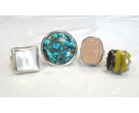 FOUR LARGE SILVER DRESS RINGSset with rose quartz, mother of pearl, turquoise and stone respectively (4)