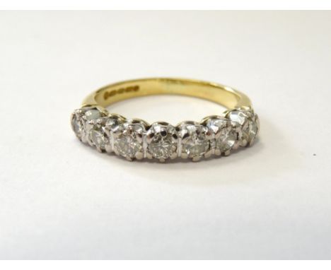 DIAMOND SEVEN STONE DRESS RINGset in eighteen carat gold, the diamonds totalling approximately 0.50 of a carat, size K-L