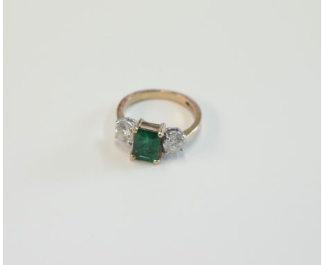18ct yellow and white gold ring, set with centre fine emerald cut Emerald, approx. 1.15ct, with single Diamond each side, app