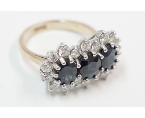 18ct yellow and white gold cluster ring, set with 3 centre oval Sapphires, surrounded by 18 round Diamonds. Size K/L. Total i