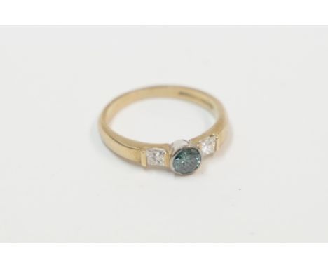 18ct yellow and white gold ring, set with single round blue Diamond, approx. 0.29ct, with a Princess Cut Diamond set each sid