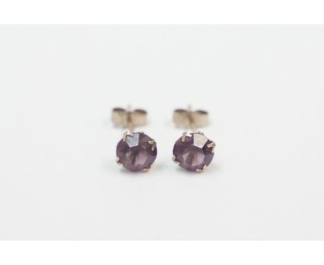 Pair of 9ct yellow gold Amethyst stud earrings. Total item weight approximately 0.93 grams