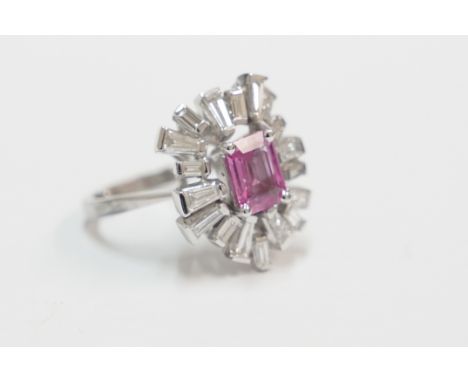 Platinum dress ring, set with 8mm x 6mm octagonal pink Sapphire, surrounded by 18 tapered and rectangular baguette Diamond, a