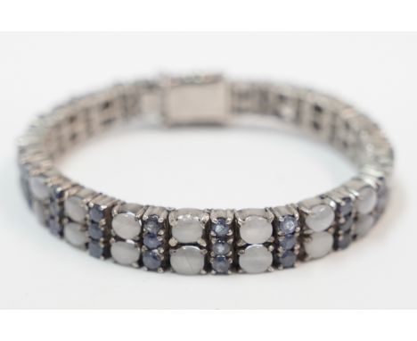 Silver double row blue and white stone set bracelet.Total item weight approximately 37.66 grams.