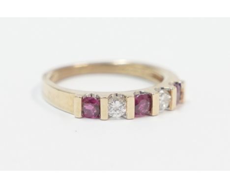 18ct ring, set with 2 round Diamonds, approx. 0.10ct each and 3 x 3mm Rubies. Size L. Total item weight approximately 3.83 gr