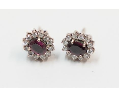 Pair of 9ct Ruby and Diamond cluster earrings.Total item weight approx 2.9 grams.