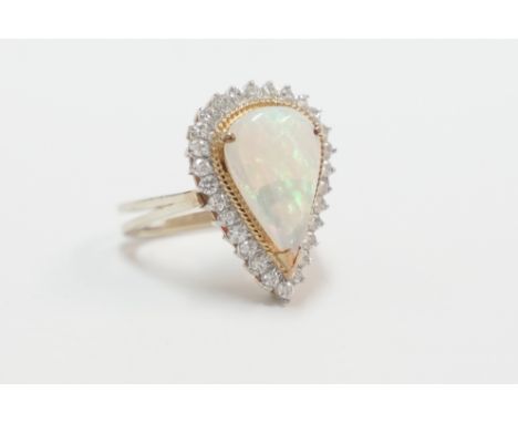 14ct yellow and white gold ring, set with fine colour tear shaped Opal, surrounded by 28 round cut Diamonds, approx. 0.50ct t