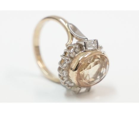18ct ring, set with oval Citrine, with Baguette Diamond each side, with 8 small round Diamonds at the top and 8 small Diamond