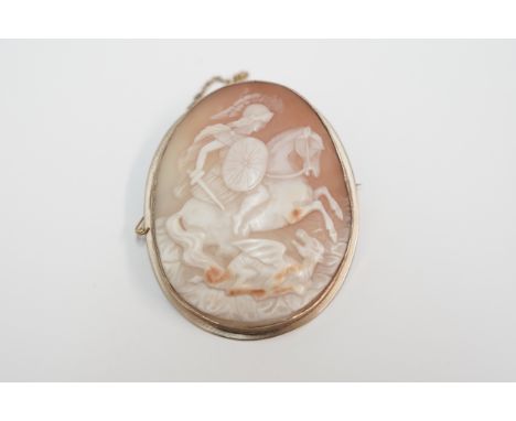 Cameo brooch depicting knight on horseback. No hallmarks. Total item weight approximately 19.83 grams.