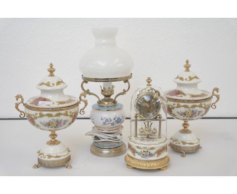 A paid of gilt metal and ceramic pedestal vases, an anniversary clock and an electric lamp shape table lamp