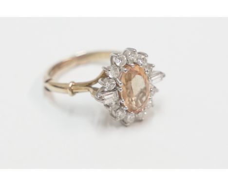 18ct yellow and white gold cluster ring. Oval golden Citrine surrounded by 16 round brilliant cut Diamonds and baguette Diamo