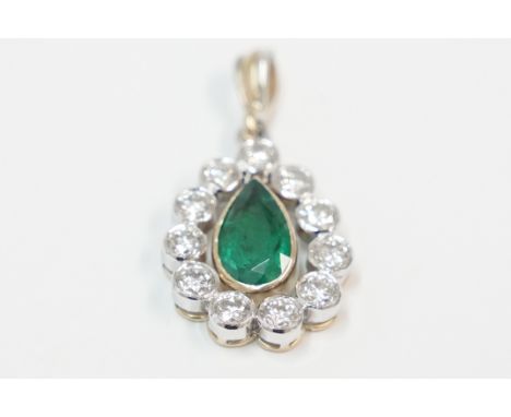18ct yellow and white gold pendant set with 11 round Diamonds, approx. 2.75cts total weight, surrounding 1 pear shaped Emeral