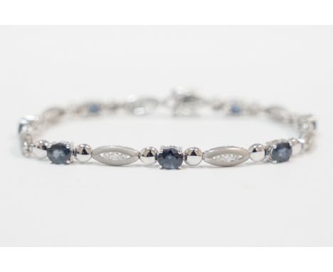 18ct white gold bracelet, set with 7 oval 5mm x 4mm mid-blue Sapphires and 21 round Diamonds, approx. 0.60cts total weight. T