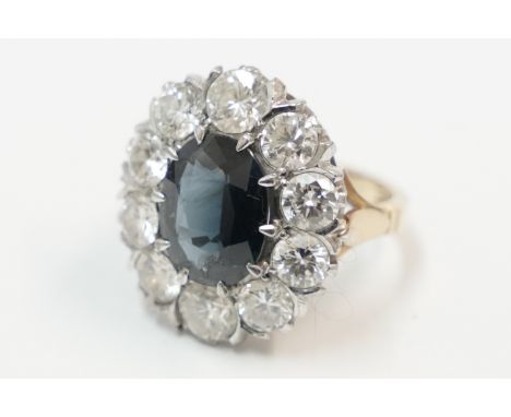 18ct yellow and white gold cluster ring, set with centre oval Sapphire, surrounded by 10 round Diamonds, approx. 3.00ct total