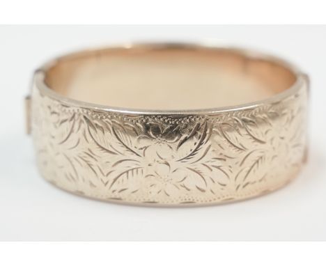 9ct yellow gold half engraved metal core bangle.&nbsp;&nbsp;Total item weight approximately 53.65 grams.