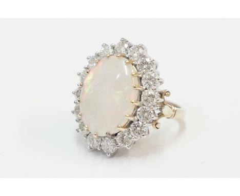 18ct yellow and white gold ring, set with single fine colour Opal, approx. 17mm x 12.5mm, approx. 4.61 cts, surrounded by 16 
