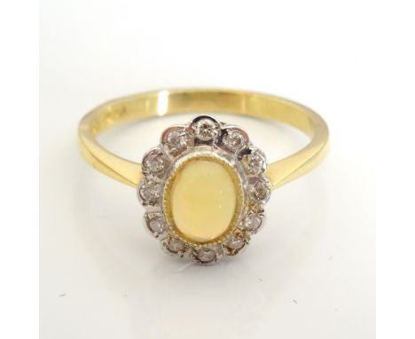 OPAL AND DIAMOND CLUSTER RINGthe central cabochon opal in twelve diamond surround, on eighteen carat gold shank, ring size O