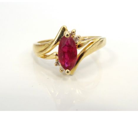 RUBY AND DIAMOND DRESS RINGthe central marquise cut ruby approximately 0.5cts, on fourteen carat gold shank marked 'Magic Glo