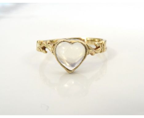 PRETTY HEART SHAPED MOONSTONE RINGon unmarked gold shank with scroll decorated shoulders, ring size N-O