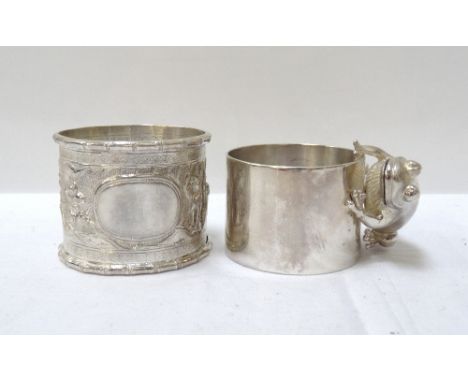 SILVER NAPKIN RINGwith applied unmarked silver frog, maker 'Drummond'; and a relief decorated unmarked Chinese silver napkin 