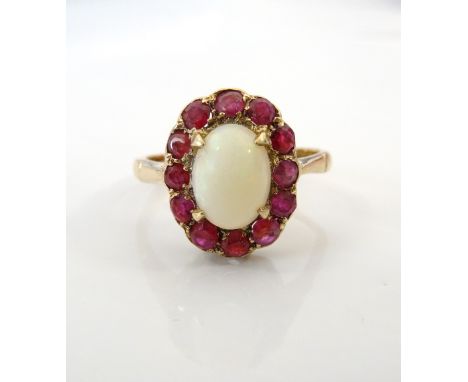 OPAL AND RUBY CLUSTER RINGthe central oval cabochon opal in twelve ruby surround, on nine carat gold shank, ring size K