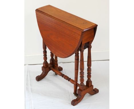 LATE VICTORIAN OAK SUTHERLAND TABLEwith oval top, raised on turned legs and stretchers with ceramic castors