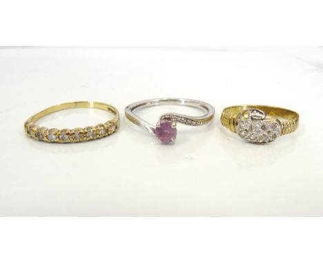 THREE NINE CARAT GOLD RINGSone set with amethyst and diamond, another with CZ and the last with clear gems, ring sizes M, E-F