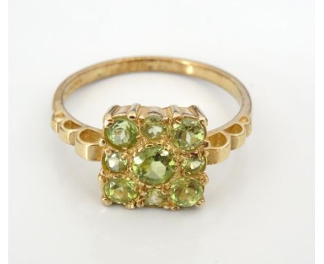 PERIDOT CLUSTER RINGthe nine graduated peridots in square setting, on nine carat gold shank, ring size N-O