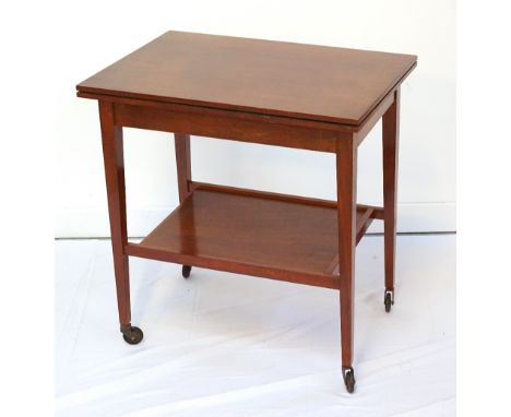 VINTAGE MAHOGANY FOLD-OVER CARD TABLE/TROLLEYthe swivel top revealing hidden compartment, with undertier and raised on taperi