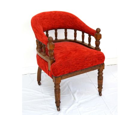 EDWARDIAN OAK FRAME HOOP BACK ARMCHAIRwith a shaped padded back and arms supported by turned supports above a stuffover seat,