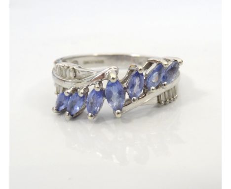 ATTRACTIVE TANZANITE AND DIAMOND CLUSTER RINGthe seven graduated marquise cut tanzanites totalling approximately 0.35cts flan