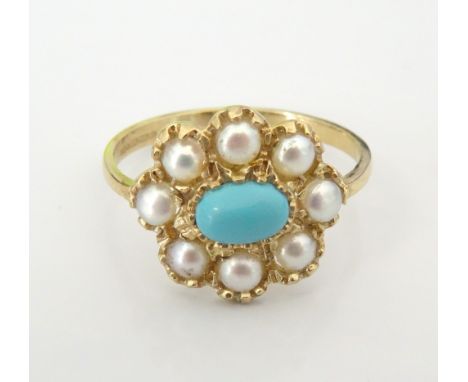 TURQUOISE AND PEARL CLUSTER RINGthe central oval cabochon turquoise in surround of eight pearls, on nine carat gold shank, ri
