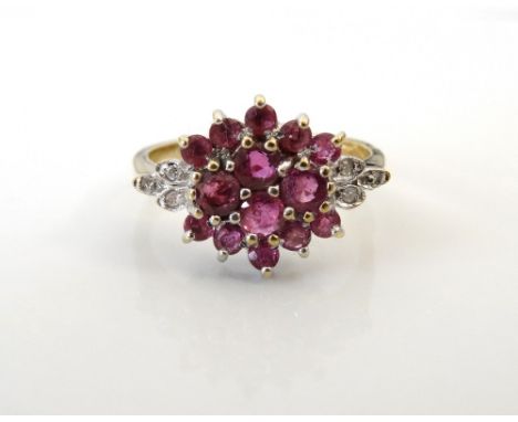 RUBY AND DIAMOND CLUSTER DRESS RINGthe central fourteen rubies flanked by three diamonds to each shoulder, on nine carat gold