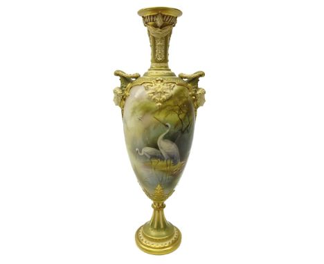 Royal Worcester porcelain twin handled pedestal vase, painted with two wading storks in a misty woodland landscape, signed by