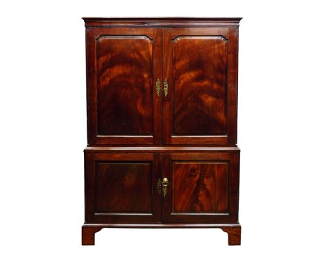 George II mahogany linen press, projecting cornice above two figured stepped ogee panelled doors, interior lined with damask 