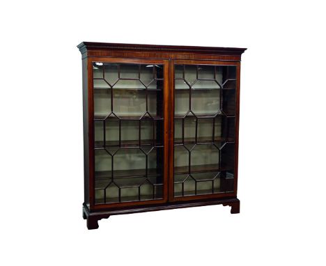 Large Georgian mahogany free standing bookcase, projecting cornice with dentil detail, two astragal glazed doors, eight adjus