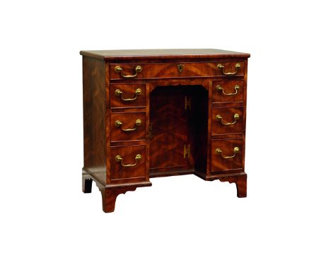 20th century Georgian style mulberry wood kneehole desk with an arrangement of seven drawers and a cupboard on shaped bracket