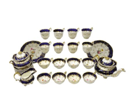 Early 19th century tea service for eight persons, moulded gilt rim, floral hand painted panels on cobalt blue ground, compris