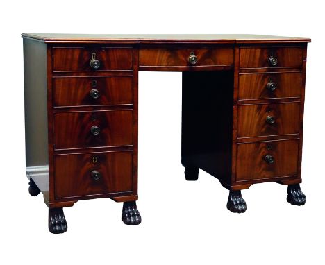 Regency period mahogany kneehole desk, reeded bow break front top above nine graduating figured drawers with scumbled paper l