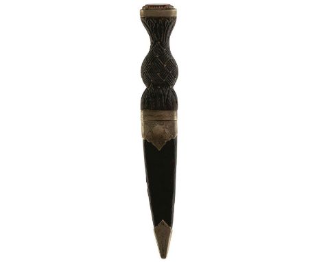 A SCOTTISH SGIAN DUBH, 9.5cm blade with engraved wavy decoration, characteristic white metal mounted hilt, the pommel set wit