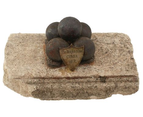 OF CRIMEAN WAR INTEREST, five cannon balls mounted on a fragment of stone lintel, with shield shaped plaque inscribed The Hei