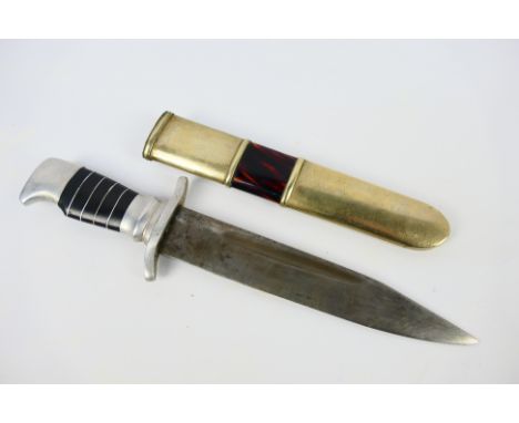 A World War Two alloy hilt fighting knife with 17 cm (l) blade and S shaped crossguard, approximately 26 cm (l) overall. [W]
