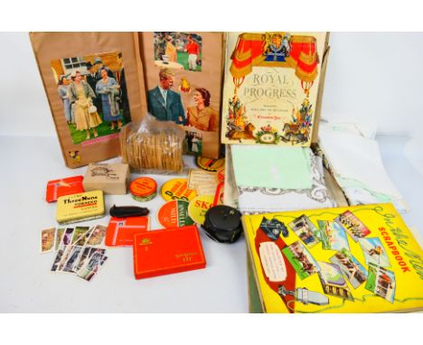 A mixed lot to include vintage linen, royal related scrapbooks and ephemera, fishing reel, knife with marlin spike and other.