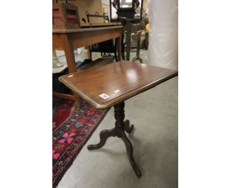 A 19th century tripod based table with later top.