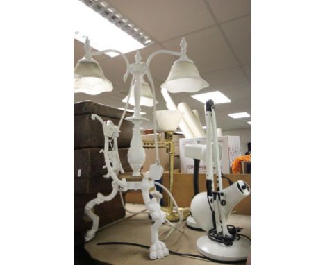 Cast metal lamp with glass shades, on tripod feet featuring a Cherub on swing plus three other lamps